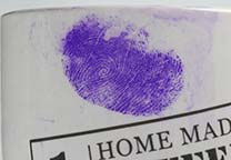 Thumbprint in blood on coffee mug stained with Acid Violet 17.