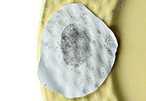 Fingerprint dusted with black powder and lifted with Silmark white