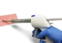 Dispenser with cartridge and mixing tip in use on a test impression.