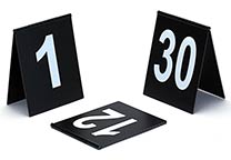 Number signs (several number ranges available), tent design, with hinge on the top. Black with white printing. Dimensions: 9 x 11 cm.